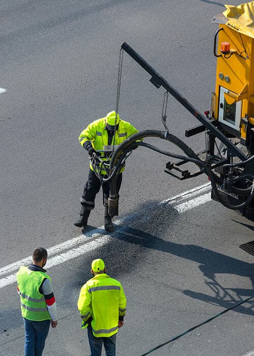 asphalt technicians filling asphalt cracks on Utah roadways - Morgan Pavement